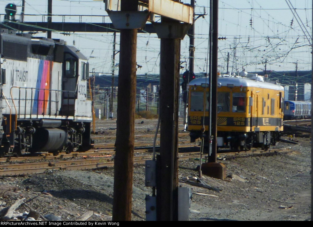 Sperry Rail Service railcar 125 at Hudson Interlocking with NJT GP40-2 4303